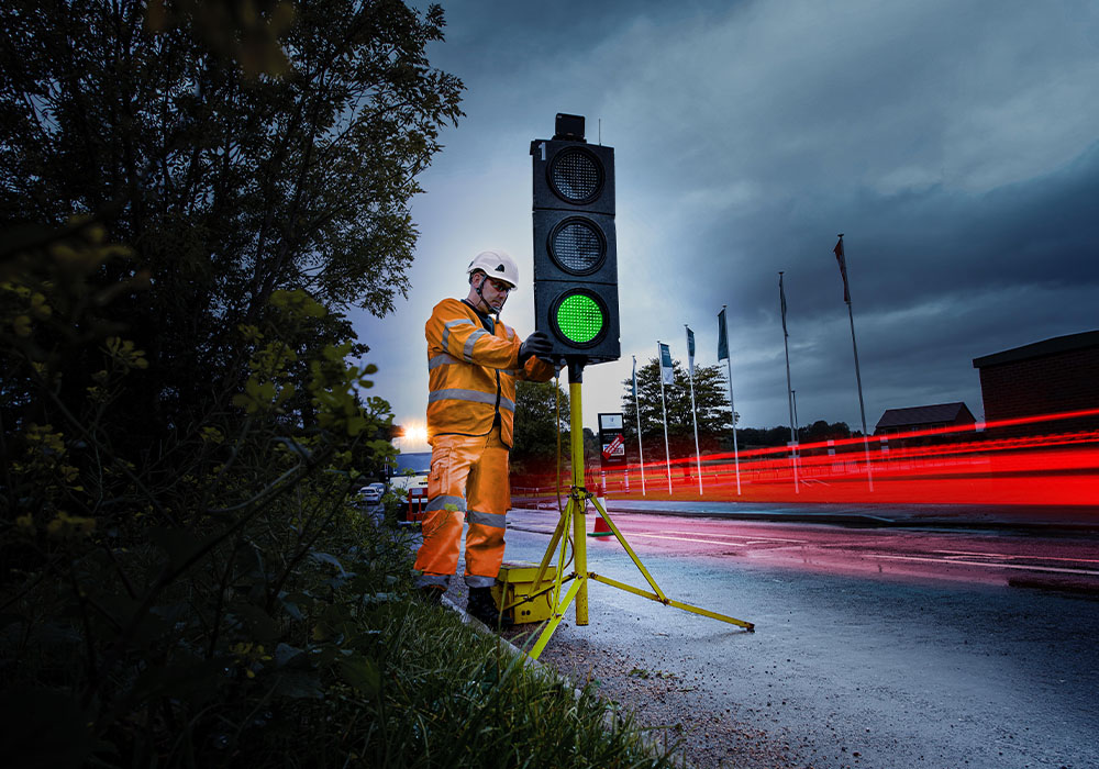 A Sunbelt employee adjusts a traffic light