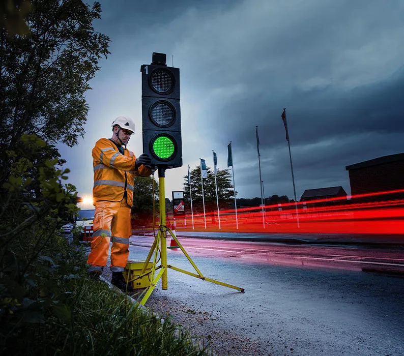 A Sunbelt employee adjusts a traffic light